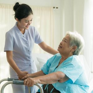 高齢患者と話をする看護師