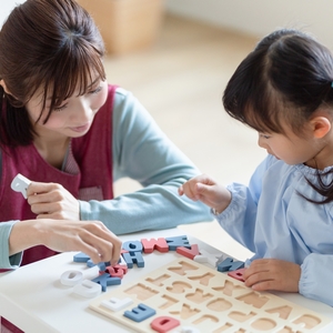 子どもと遊ぶ保育士 